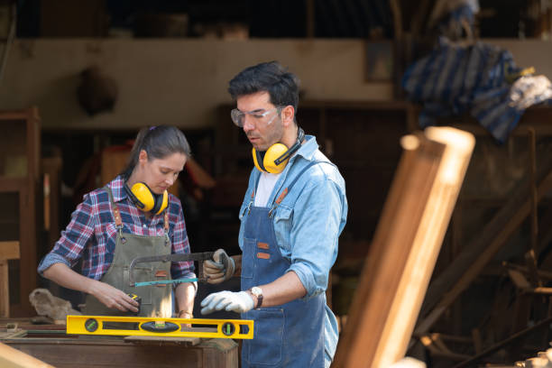 istock Carpenter and his assistant working together in a carpentry workshop 1976617339