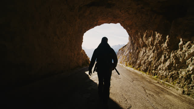 SLO MO Emerging into Radiance: Lone Hiker Conquers Mountain Tunnel