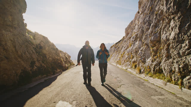 SLO MO Embarking Together: Adventurous Couple Ventures into Mountain Tunnel