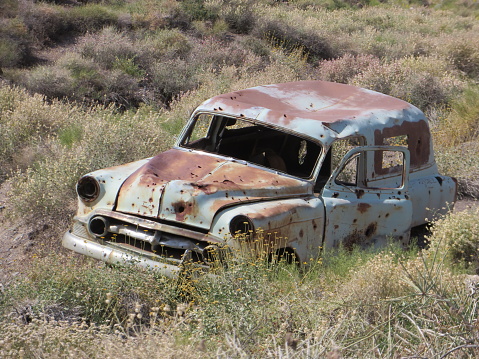 Old Rusty Blue Classic Car Abandoned in Death Valley National Park by Aguereberry Camp. High quality photo