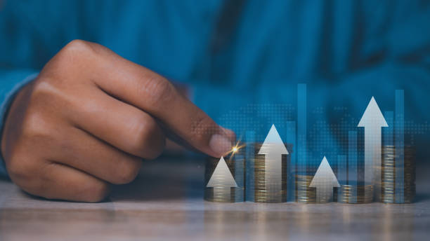 istock Businessman stacking coins with screen forex trading graph financial data. Goal business profit graph development. Stock market, financial growth report. 1976659154