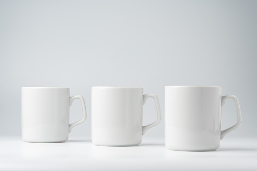Blank white mugs mock up on white background copy space