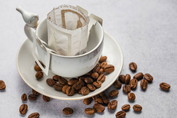 istock Drip coffee bag with ground coffee in  cup 1976720480
