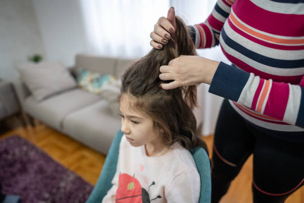 istock Mother combs her cute little daughter's hair 1976727298