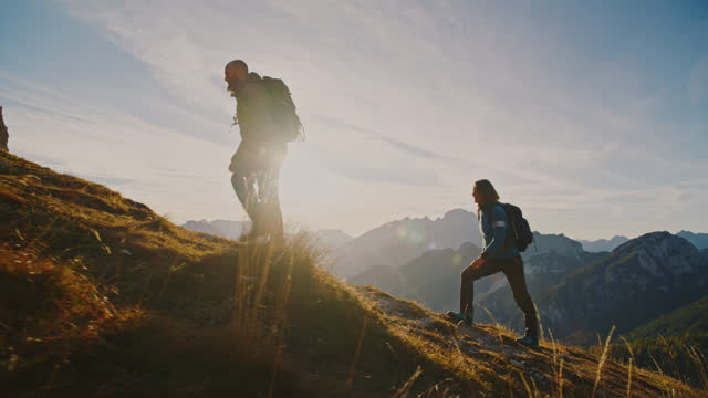 SLO MO Ascending Together: Couple Conquers Mountain Heights at Sunset