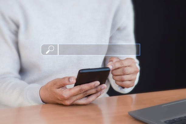 istock Searching the internet with a search bar working on a smartphone, internet network concept. 1976745434