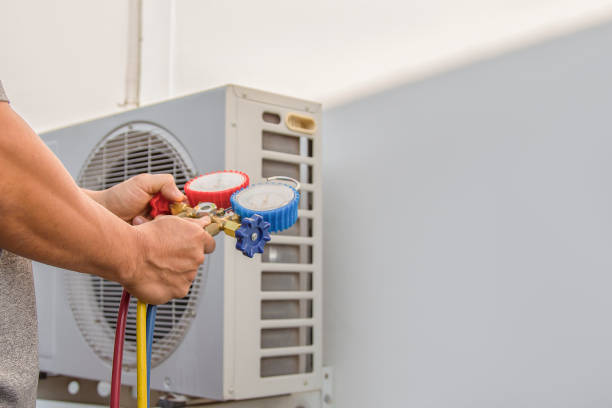istock Air conditioning, HVAC service technician using gauges to check refrigerant and add refrigerant. 1976746481