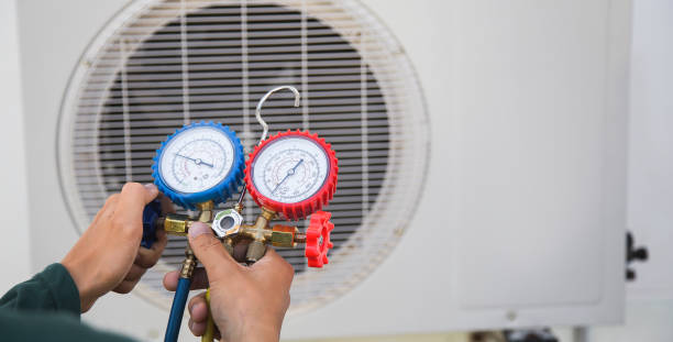istock Air conditioning, HVAC service technician using gauges to check refrigerant and add refrigerant. 1976747040