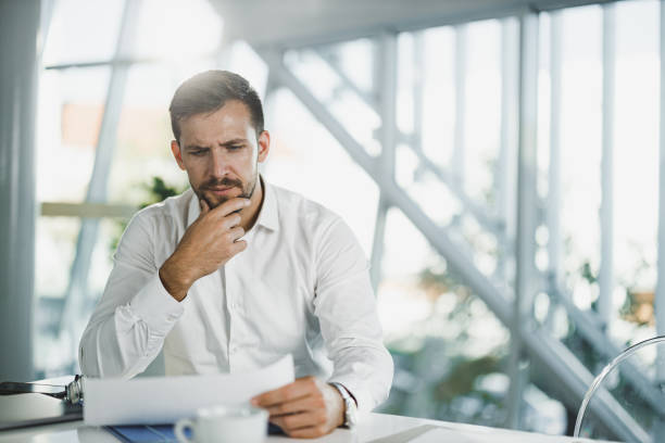 istock Thoughtful businessman analyzing reports in the office. 1976764298