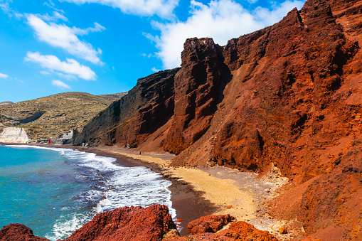 Red beach in Santorini island, Greece. Red volcanic cliffs and the blue sea. Summer landscape at sunny day