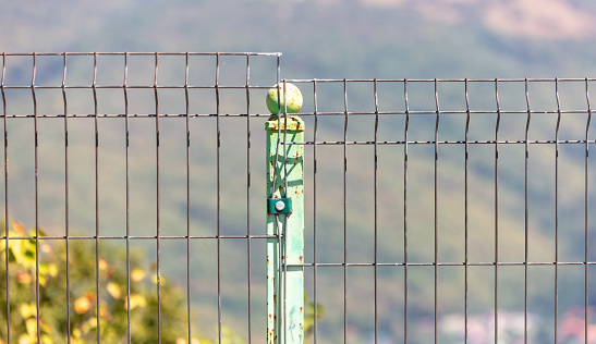 Metal fence in nature as a background.