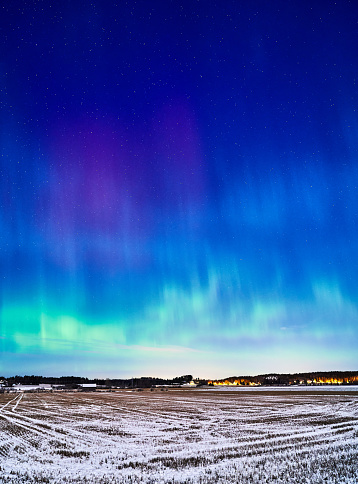 A stunning display of the aurora borealis illuminating the sky and a picturesque field