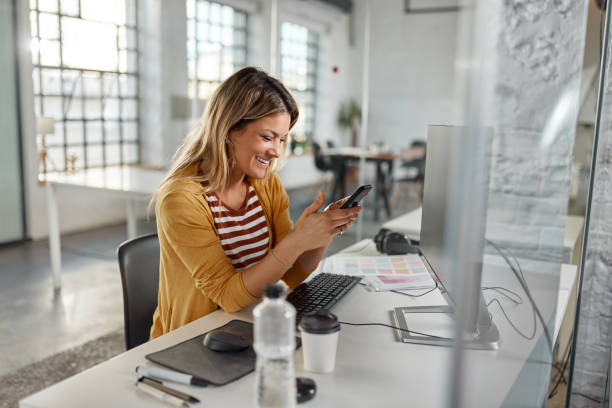 istock Happy businesswoman using mobile phone at corporate office. 1976848208