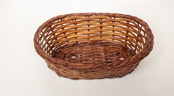 Small brown basket on white background