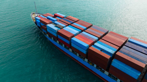 istock logistic cargo container ship sailing in sea to import export goods and distributing products to dealer and consumers across worldwide, aerial side view 1976888426
