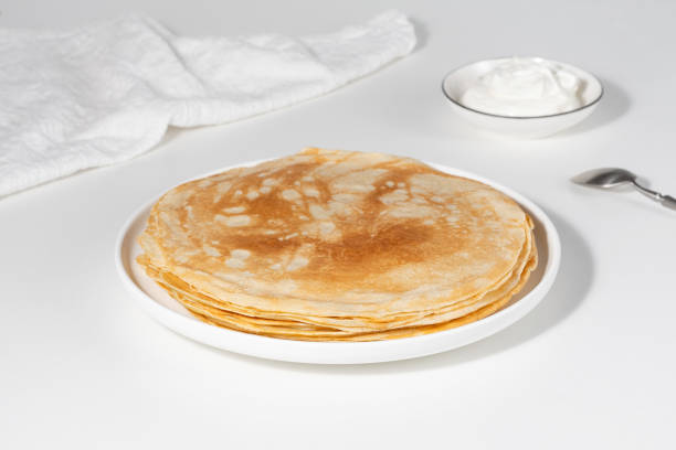 istock Thin pancakes in a plate. Concept of delicious breakfast or Maslenitsa 1976888586