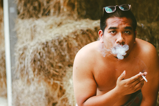 fat asian man smoking