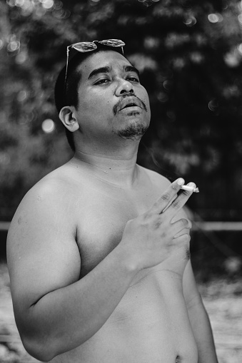 fat asian man smoking