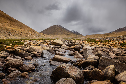 River at Warila pass in between peaks of the greater Himalayas, en route Leh, Ladakh