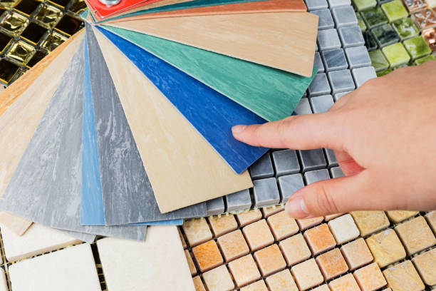 istock designer's hand choosing samples of interior stone material consists concrete tiles, quartz stones, artificial stones, graphic tile. 1976894382