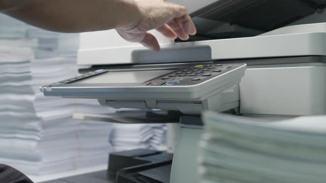 Hand of man placing a sheet of paper in the copying machine. Loopable Video