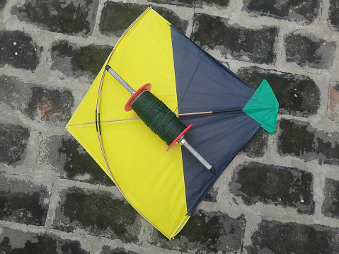 A top view of an Indian kite on a pavement