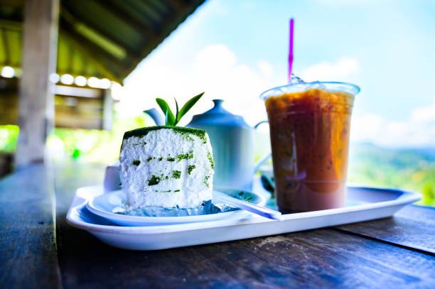 Green tea cake and beverage set with mountain view background at Chiang Mai Province