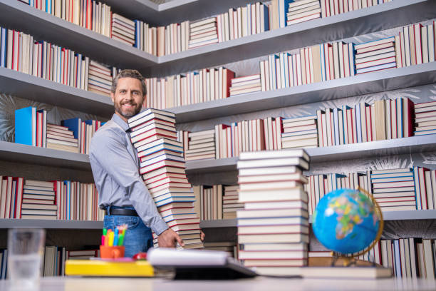 istock back to school. teachers day. education in school. knowledge day. Dive into a book. knowledge from book. man get university education. school education with man teacher. education and knowledge 1976922455
