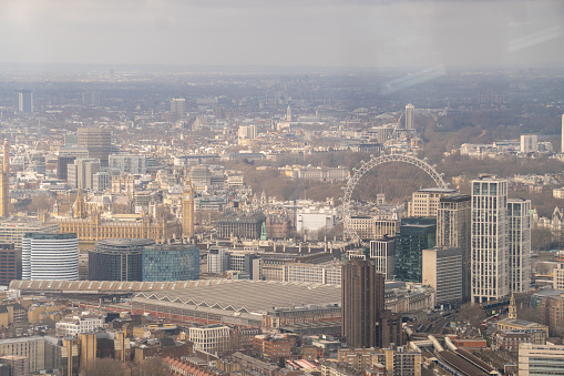 Aerial view of London at sunset, Thames River in background.