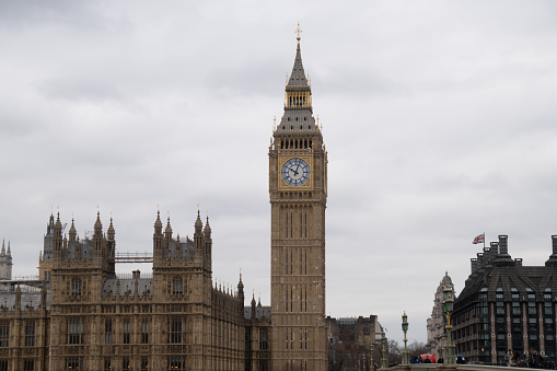 Close ups of Big Ben in London around the city and across the bridge with red buses