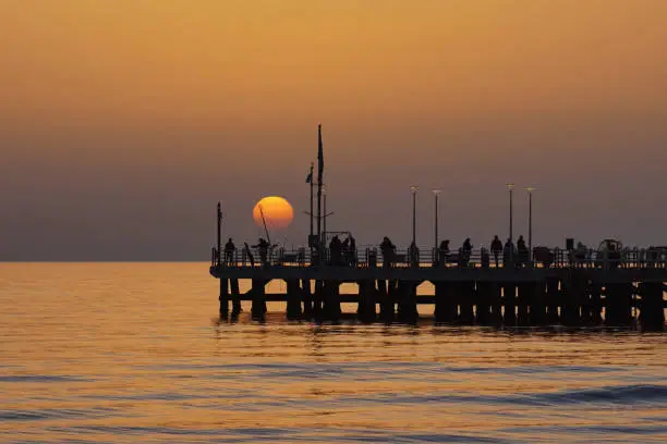 sunset with a pier at forte dei marmi in versilia