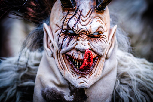 Munich, Germany - December 10: participants of the traditional Krampuslauf with costumes and wooden masks at the old town of Munich on December 10, 2023