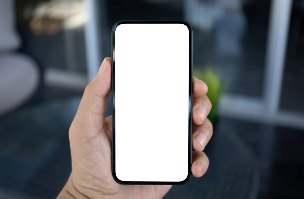 istock Male hands holding phone with screen isolated in office 1977023104