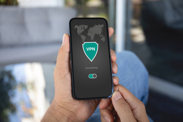 istock male hand holding phone with app vpn on the screen 1977028624