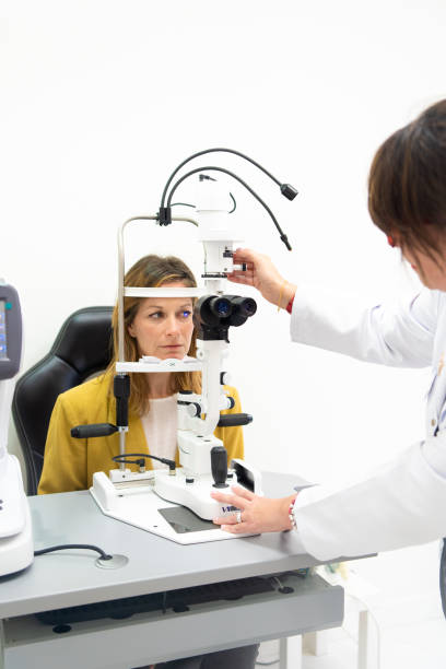 istock Doctor examining patient doing eyesight measurement in a clinic 1977029129