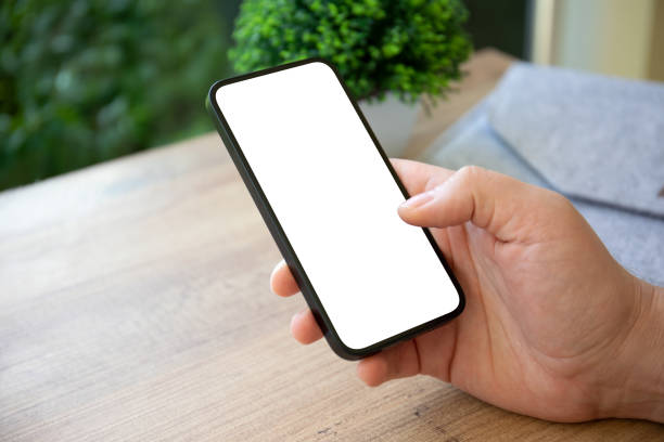 istock man hands hold phone with isolated screen on background cafe 1977029668