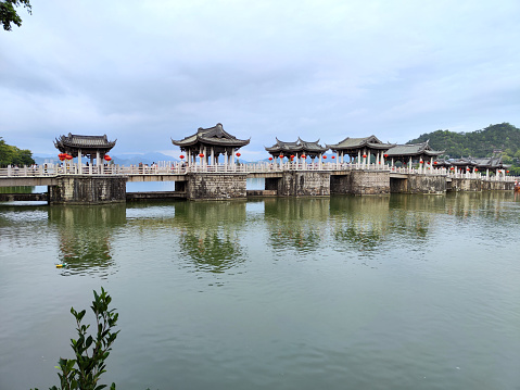 Tourists sightseeing at the Guangji Bridge, an ancient bridge that crosses the Han River east of Chaozhou, Guangdong province, China. The bridge is renowned as one of China's four famous ancient bridges. Chaozhou is a cultural center of the Chaoshan region.