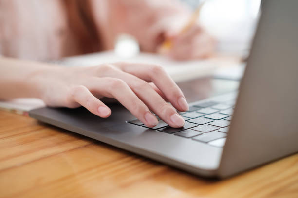 istock Hands Typing on a Modern Laptop Keyboard 1977058797