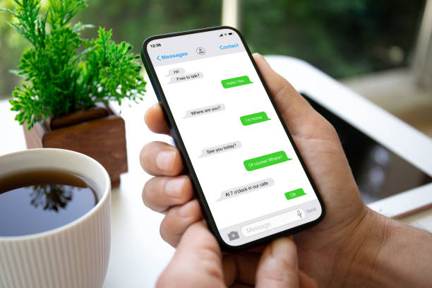 istock man hands hold phone with app messenger on the screen 1977059342