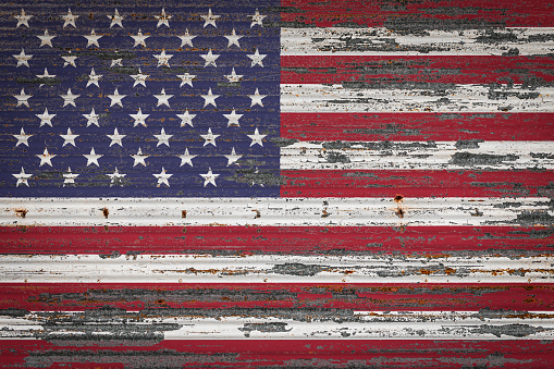 Close-up of old metal wall with national flag of USA . Concept of USA  export-import, storage of goods and national delivery of goods. Flag in grunge style