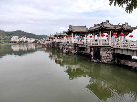 Tourists sightseeing at the Guangji Bridge, an ancient bridge that crosses the Han River east of Chaozhou, Guangdong province, China. The bridge is renowned as one of China's four famous ancient bridges. Chaozhou is a cultural center of the Chaoshan region.
