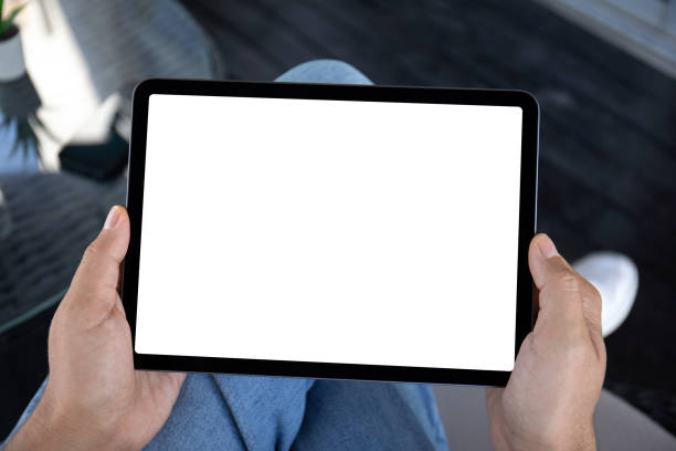 istock Male hands holding computer tablet with isolated screen in office 1977066247