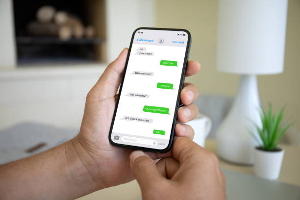 istock man hands hold phone with app messenger on the screen 1977067796