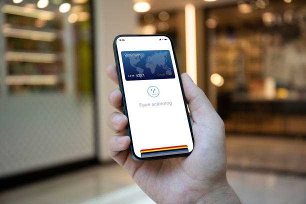 istock Male hands holding phone with face scanning id on screen 1977076745