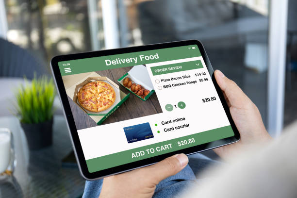 istock male hands holding computer tablet with app food delivery screen 1977079407