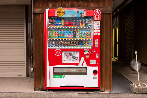 Horizontal close-up view of an illuminated and colorful soft drinks’ vending machine at night, Kyoto, Japan