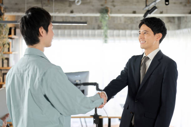 istock Businessman and worker shaking hands in the office 1977099755