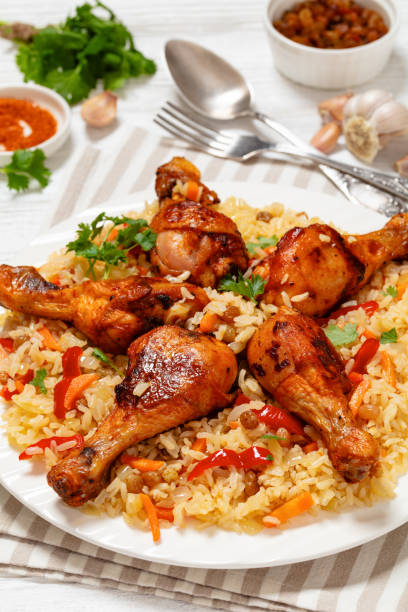 istock fried chicken drumsticks over rice pilaf, top view 1977115167