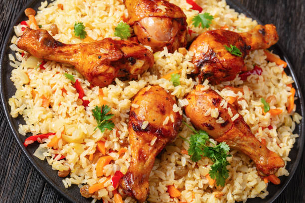 istock fried chicken drumsticks over rice pilaf, top view 1977115171