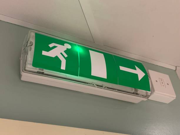 istock Emergency exit sign, attached to a wall above a doorway 1977124746